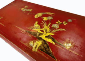Red and gilded lacquered coffee table.