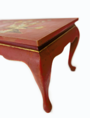 Red and gilded lacquered coffee table.