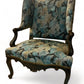 A antique 19th century French parcel gilt winged back arm chair, supported by 4 carved