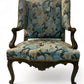 A antique 19th century French parcel gilt winged back arm chair, supported by 4 carved
