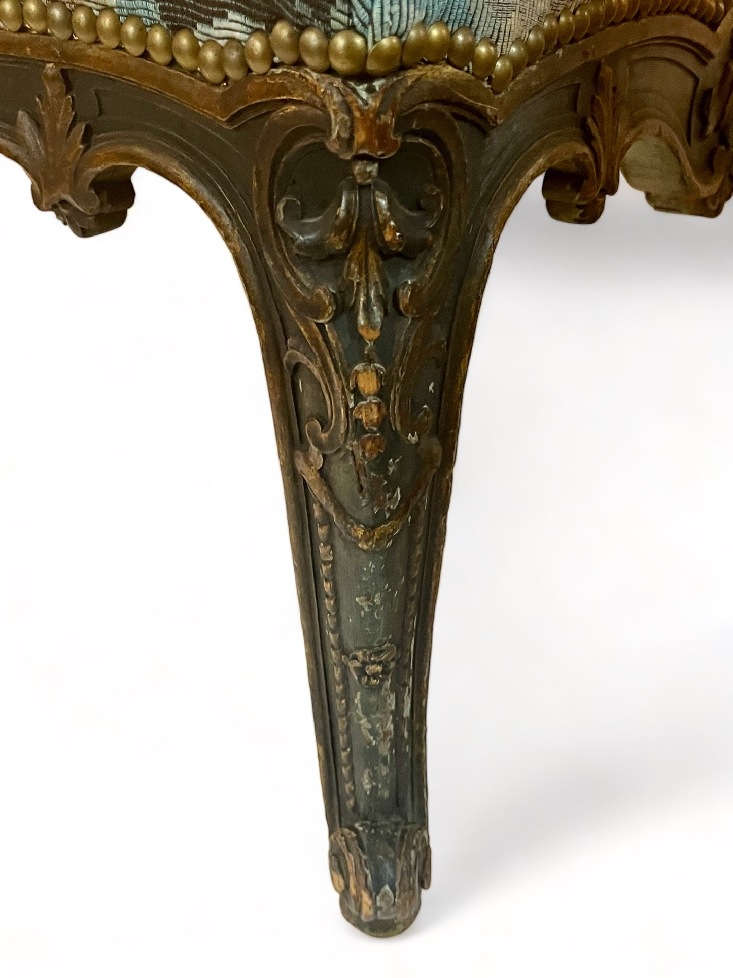 A antique 19th century French parcel gilt winged back arm chair, supported by 4 carved