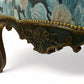 A antique 19th century French parcel gilt winged back arm chair, supported by 4 carved
