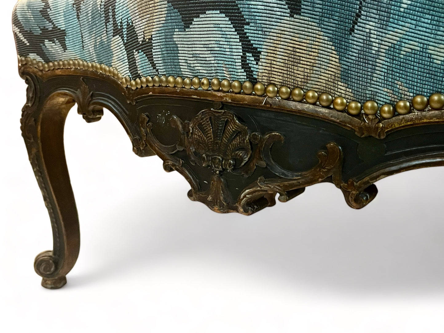 A antique 19th century French parcel gilt winged back arm chair, supported by 4 carved