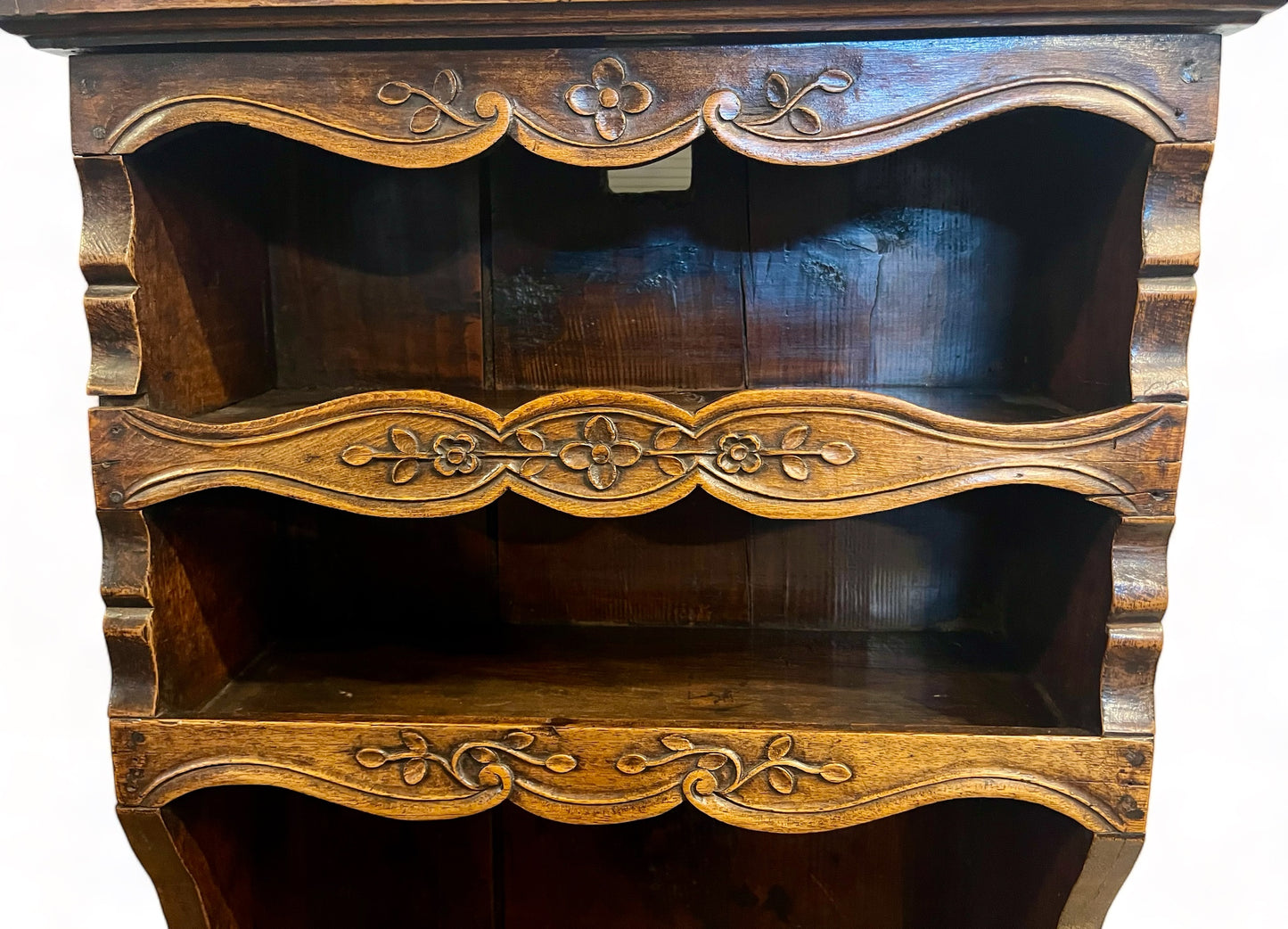 A antique 19th century French carved oak free standing spice rack, decorated with carved foliage on the front