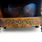 A antique 19th century French carved oak free standing spice rack, decorated with carved foliage on the front
