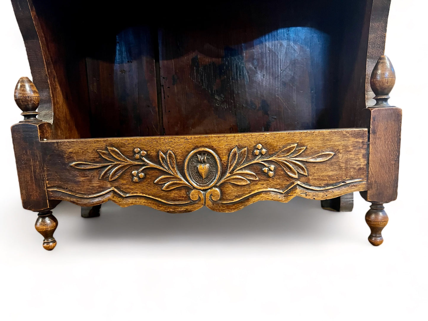 A antique 19th century French carved oak free standing spice rack, decorated with carved foliage on the front