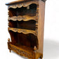 A antique 19th century French carved oak free standing spice rack, decorated with carved foliage on the front