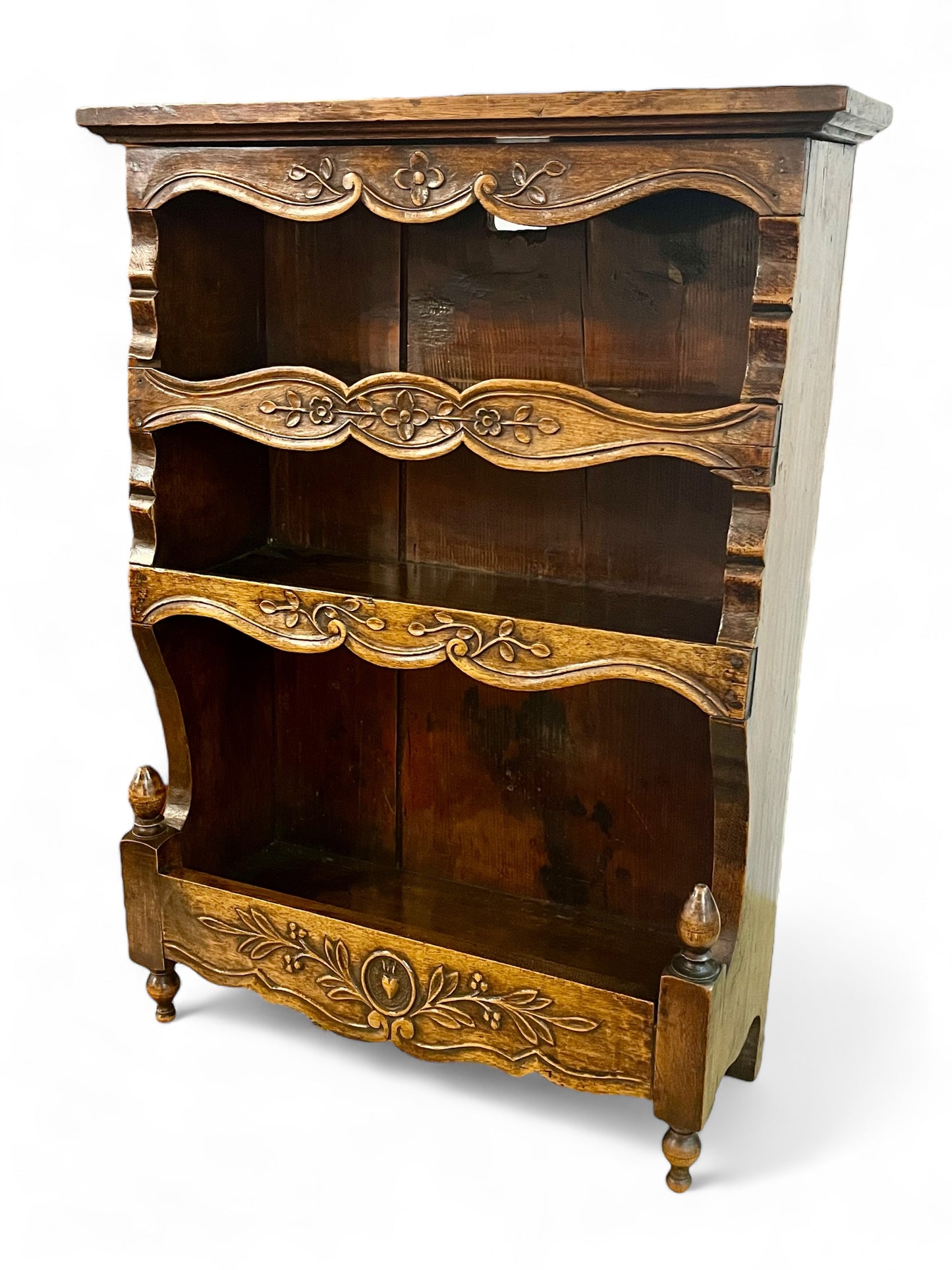 A antique 19th century French carved oak free standing spice rack, decorated with carved foliage on the front