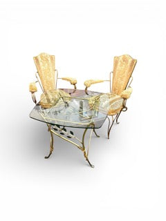 Vintage French Art Deco style wrought iron with gilt finish glass topped table with two chairs