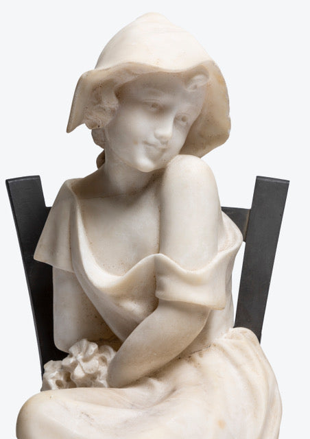 French carved Carrara marble figure of a young maiden seated in a bronze ladder back chair