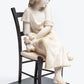 French carved Carrara marble figure of a young maiden seated in a bronze ladder back chair